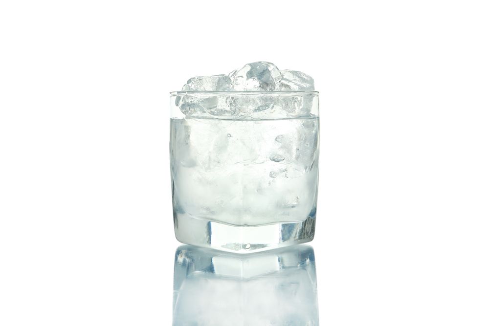 Rocks glass overflowing with ice and water