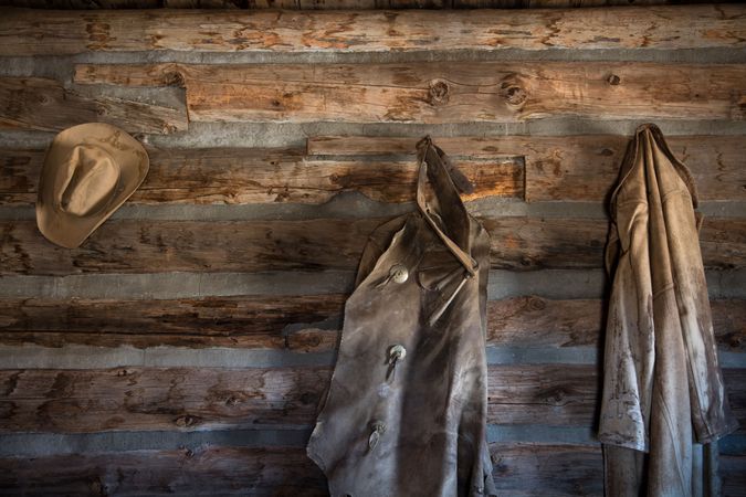 Coats and a cowboy hat at the "Hole-in-the-Wall" Cabin at Old Trail Town, Cody, Wyoming