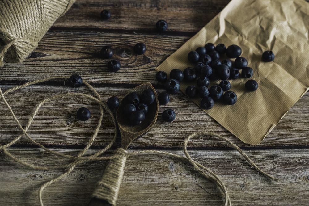Tasty bilberry on wooden surface