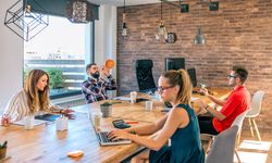 Businessmen having fun playing with a basket ball in coworking office