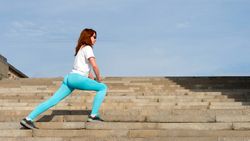 Woman doing warm up before workout on street