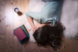 Young woman sleeping on an open book