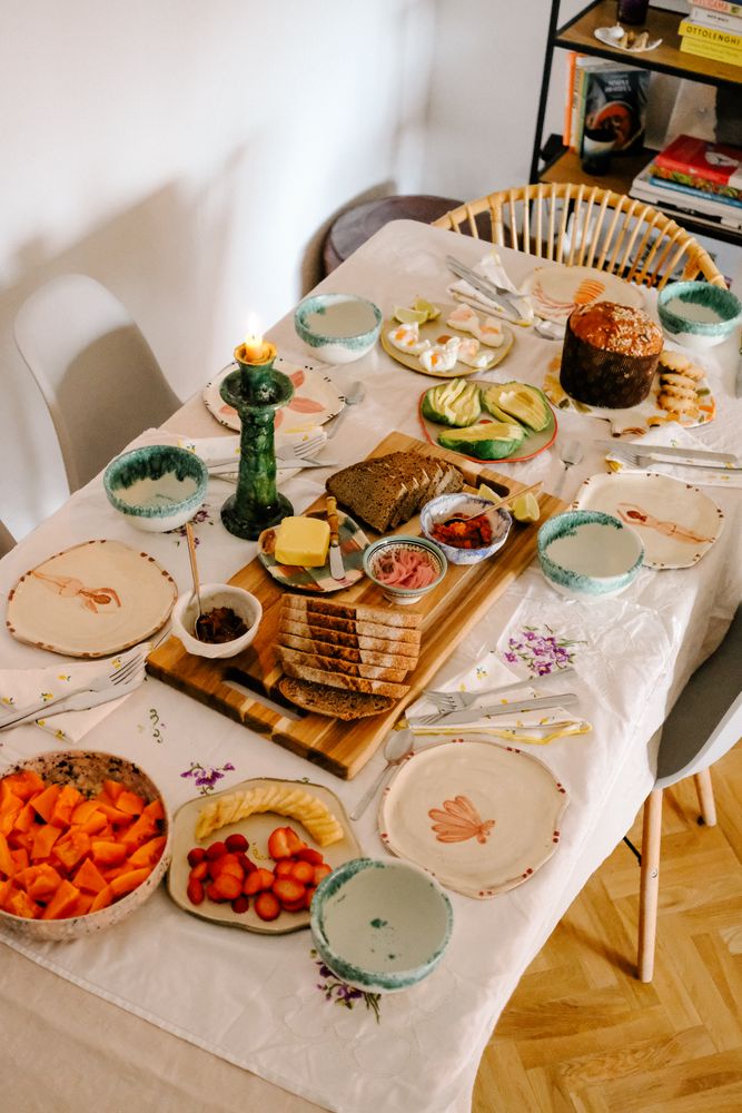Indulgent breakfast spread with poached eggs, fresh fruit, panettone.
