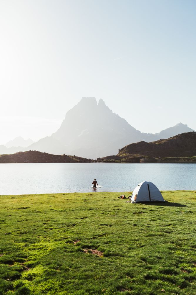 Man bathing near the tent in the mountain