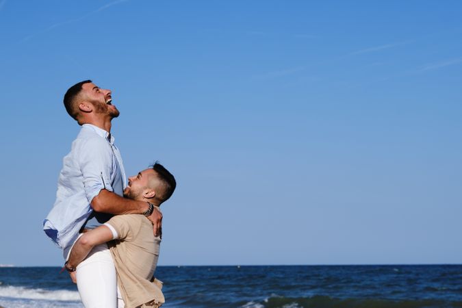 Happy gay couple enjoying and embracing outdoors