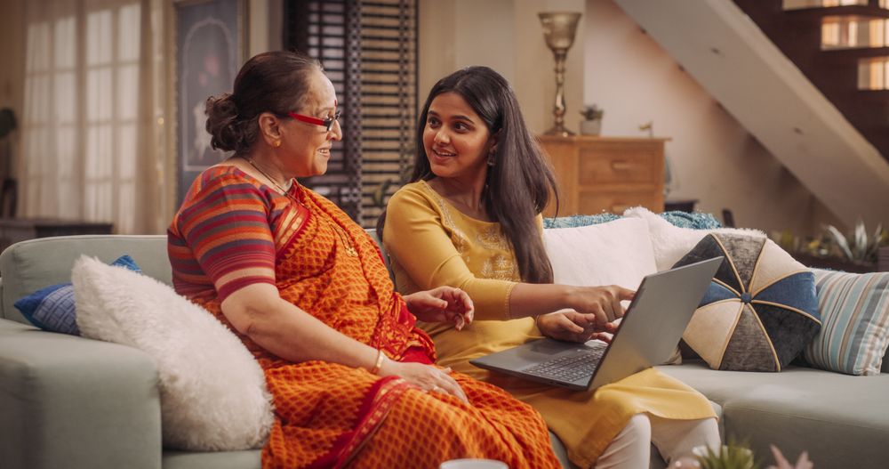 Indian Mother and Daughter Use Laptop at Home
