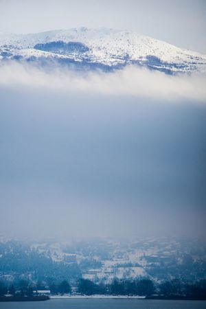 Amazing scenery of snowy mountain peak among lush clouds