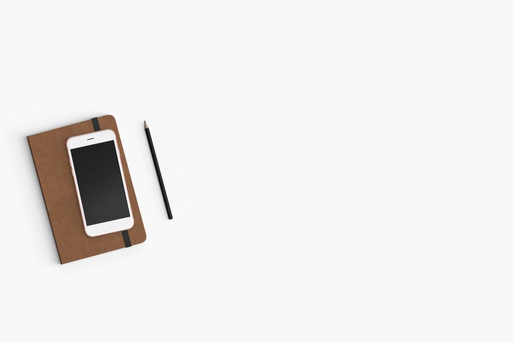 Modern workspace with smartphone, paper, notebook  copy space