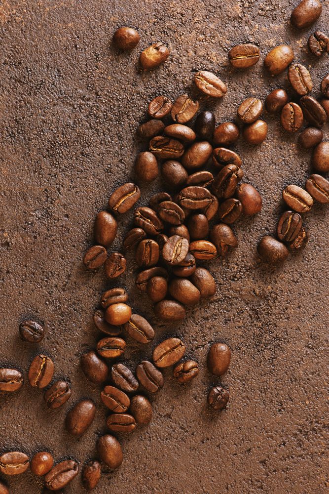 Coffee beans on brown background