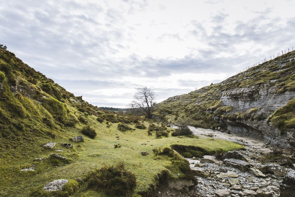 Valley between hills and cloudy sky