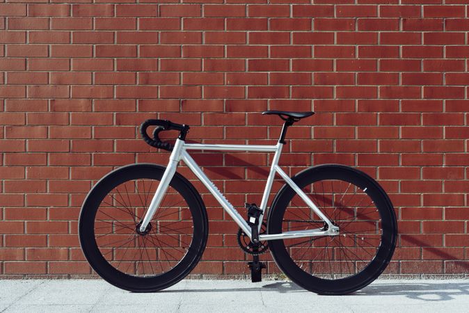 Road bicycle against brick wall