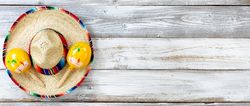Flat lay view of traditional Cinco De Mayo objects on white weathered wood