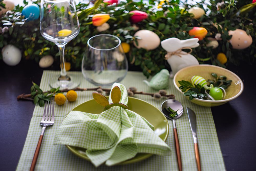 Easter table setting with rabbit napkin ring on pastel green napkin and plate