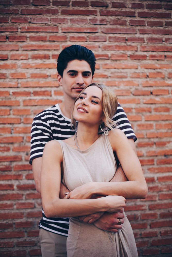 Happy couple having fun and embracing in the street