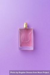 Pink perfume over purple background 4dErDb