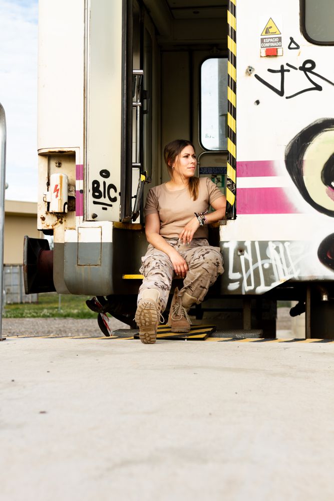 Military woman sitting near van