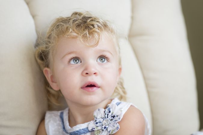 Cute Blonde and Blue Eyed Little Girl in Chair