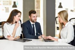 Three colleagues working together in stylish office 0vJWo0