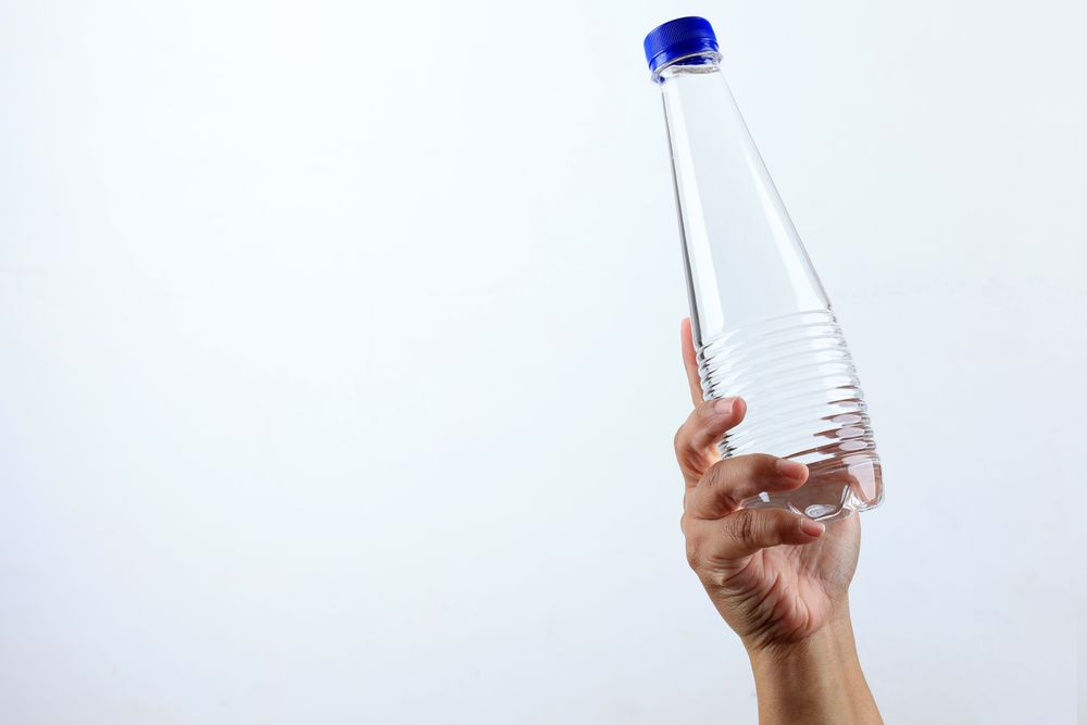 Female Hand Hold Mineral Water Bottle