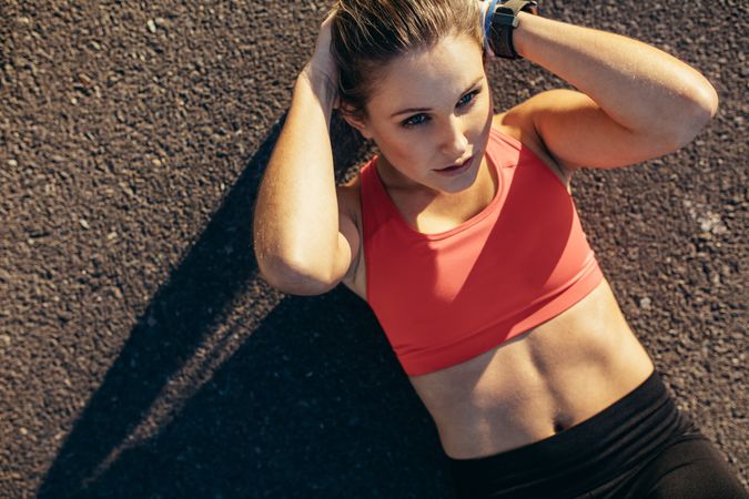 Woman doing fitness workout lying on the ground