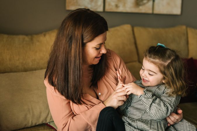 Woman hugging smiling daughter