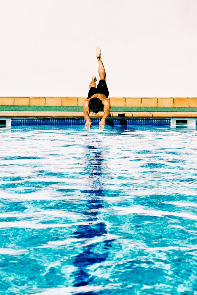 man jumps like fish into the water