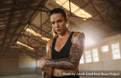 Fitness woman inside abandoned warehouse after training session 4OLdvb