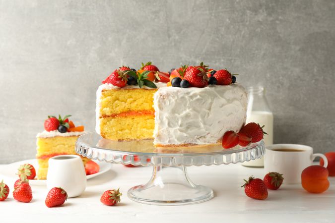 Composition with delicious berry cream cake against gray background. Tasty dessert