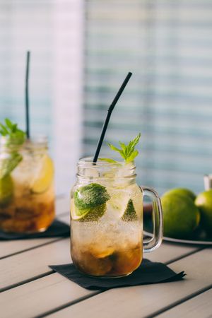 Mojitos in mason jarson wood table