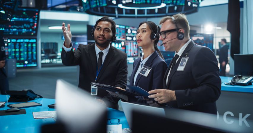 Work Day in an International Stock Exchange Hall: Multiethnic Specialists Monitoring Equity and Share Markets on Tablets and Computers, Working on Maximizing Profits for Corporate Business Partners