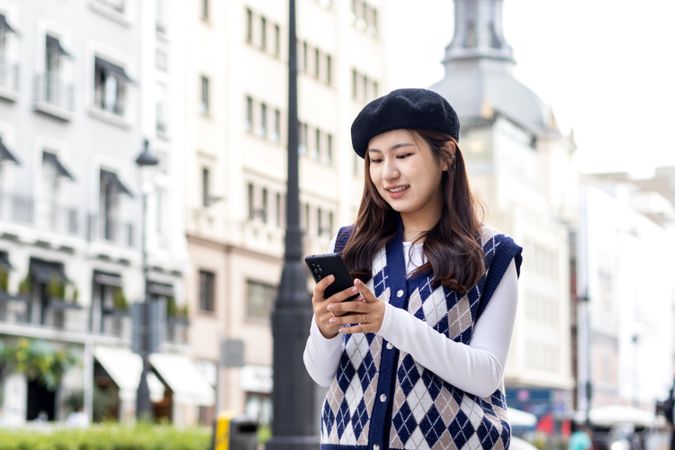 Young Asian Woman Walking and Using Smartphone in the City