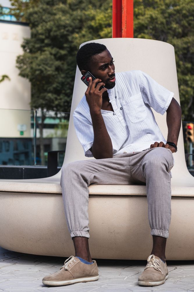 Black man talking on smartphone in city