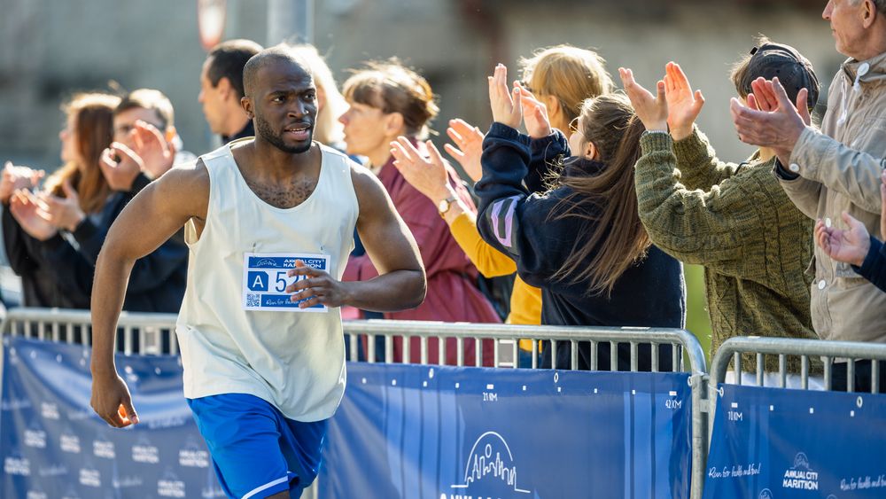 Portrait of Smiling Young Black Man Running in a City Marathon