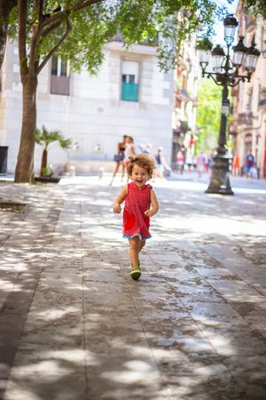 Smiling child standing on street
