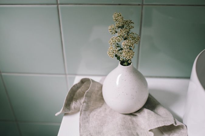 Light ceramic vase with small flowers in it
