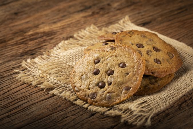 Delicious chocolate cookies on wooden table.
