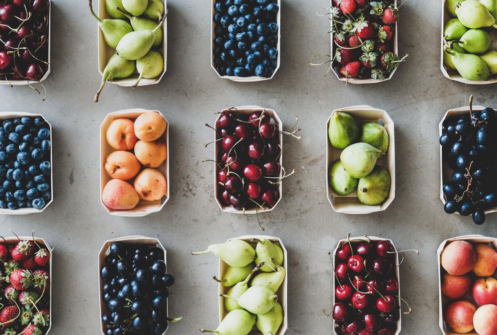 Rows of fresh fruit in eco-friendly boxed