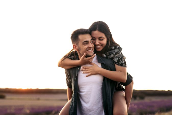 A romantic photograph of a couple in a lavender field