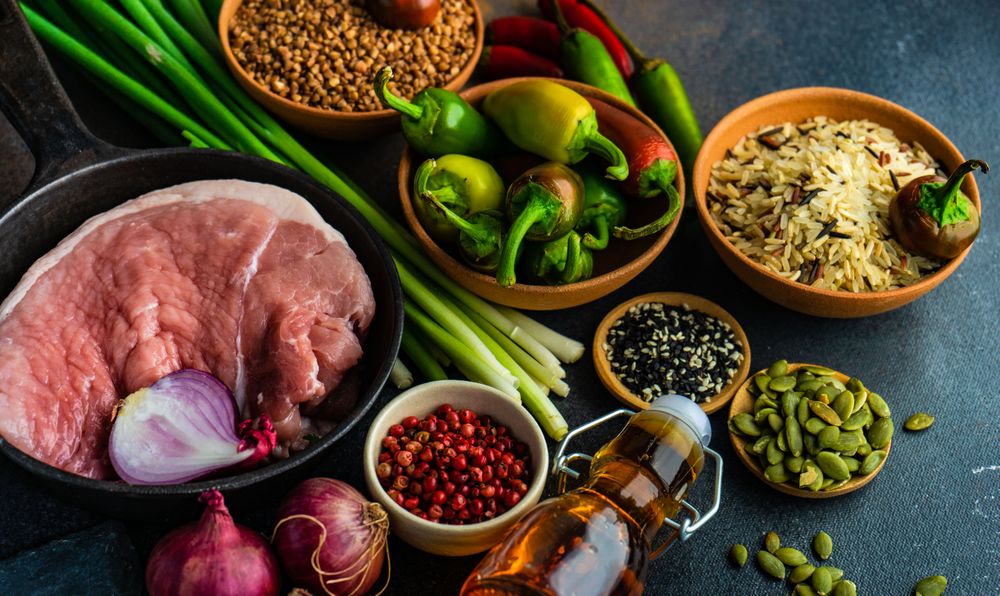 Grains and raw meat on kitchen counter for dinner prep