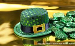 Saint Patrick celebration with coins and hat on gold background setting bDdzAb