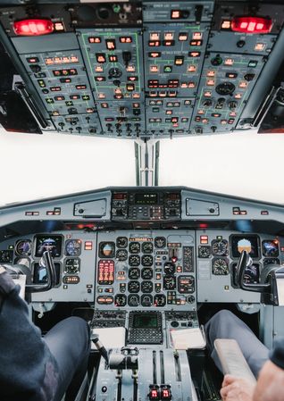 Crop pilots in cockpit of plane