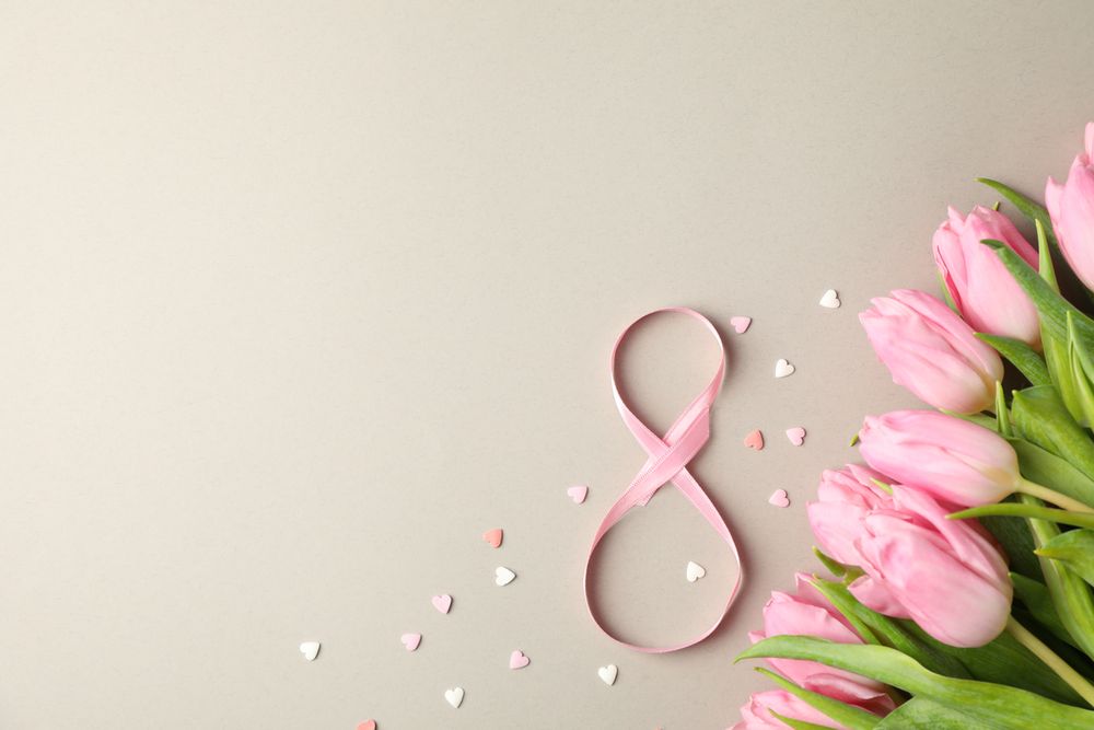 Pink tulips, candies in heart shape and 8 on grey background, space for text