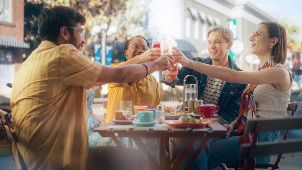 Multiethnic Diverse Friends Gathering Together at a Cafe Terrace Table.