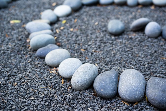 Close up of grey rocks in a circle on smaller pebbles