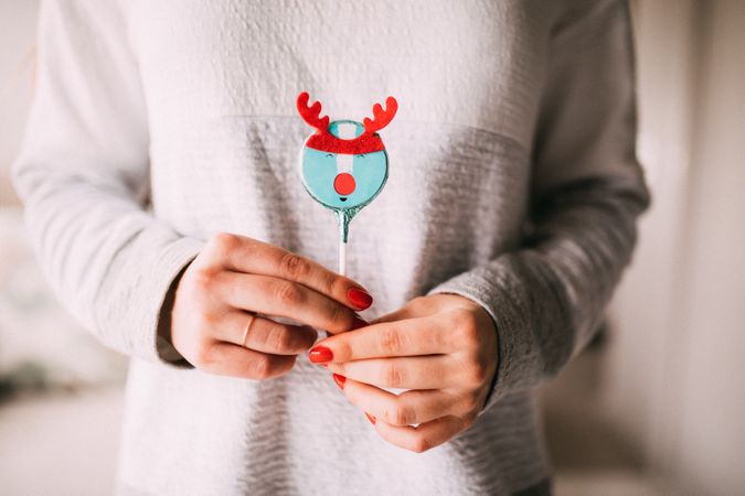 Woman holding a festive Rudolph the red nose reindeer treat