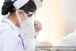 Asian nurse in protective mask and face shield 42Yox5