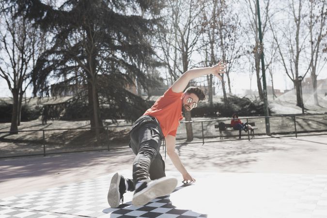 Man dancing break dance in park