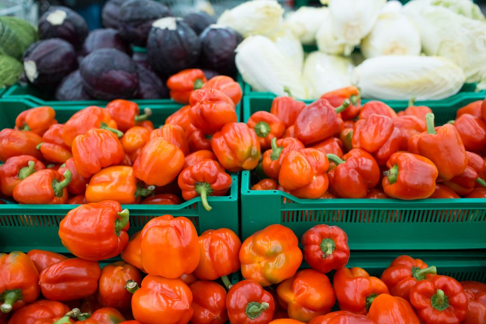 Red bell peppers in a crate at the market store