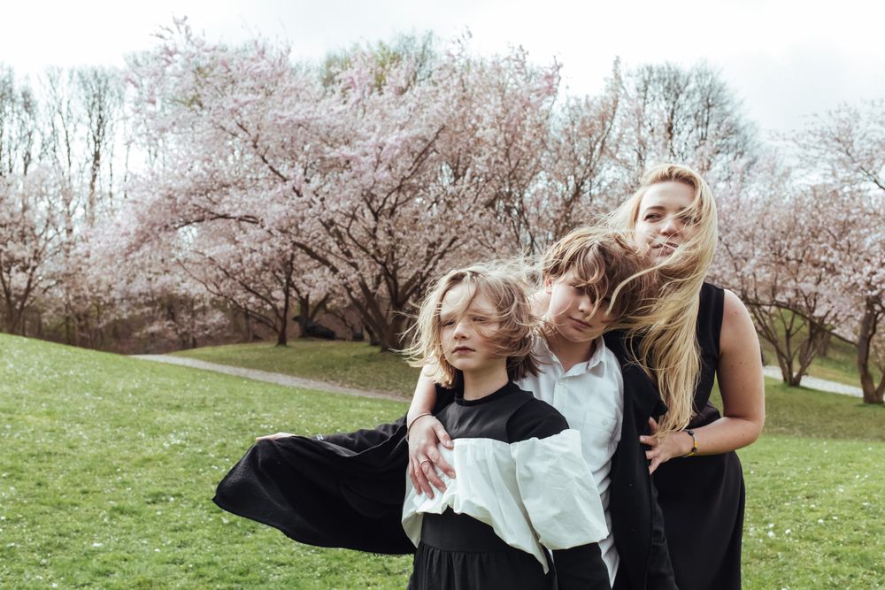Mother and children near blooming trees