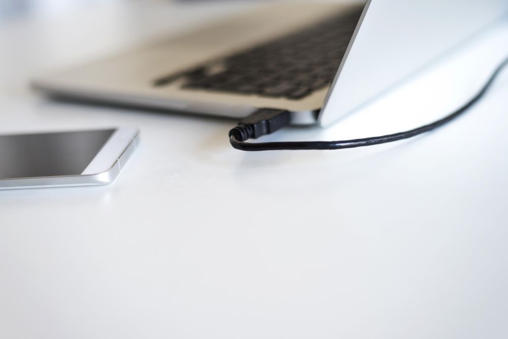 Laptop and phone on bright desk